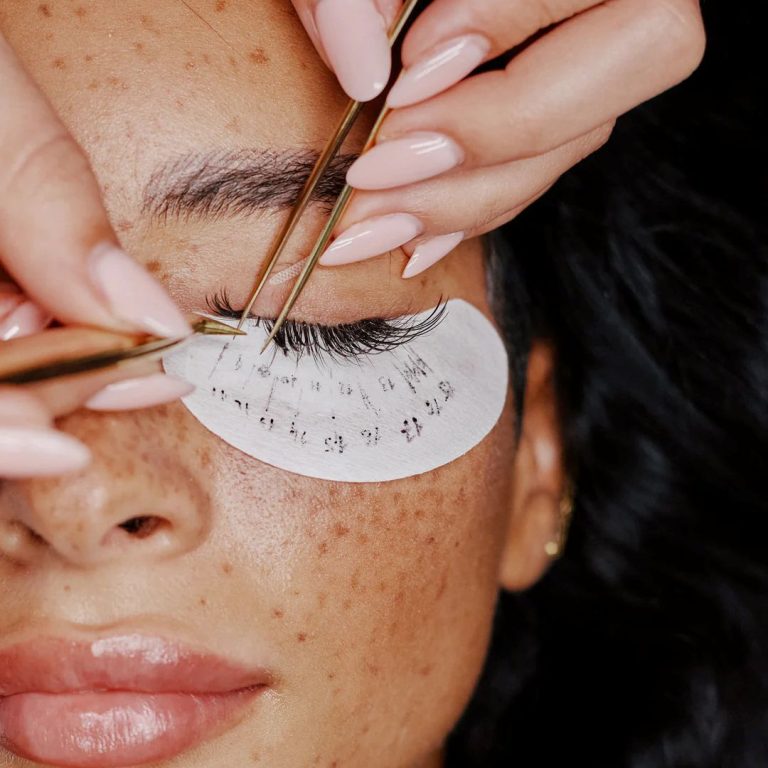 Lash extensions being individually applied during a professional lash treatment